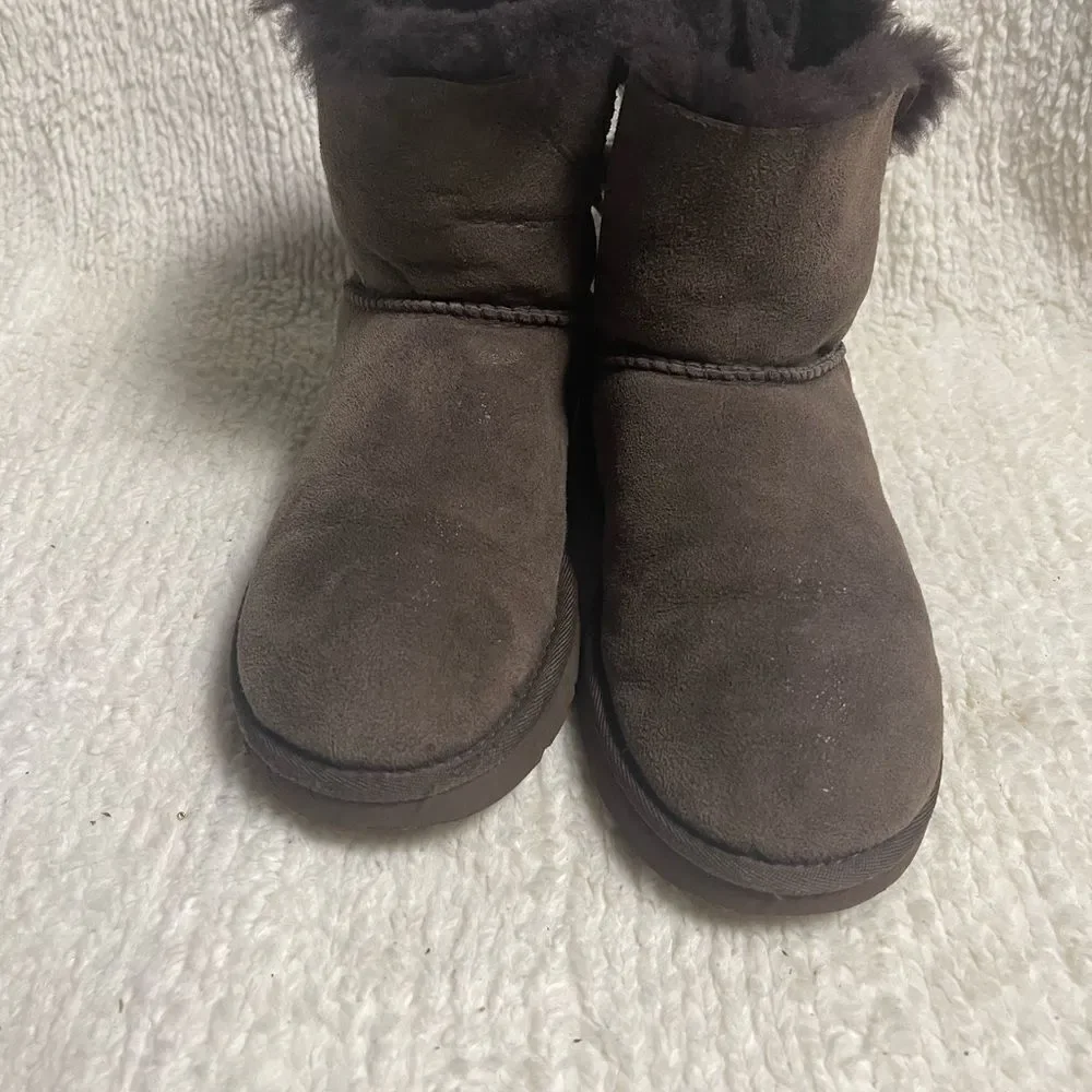 UGG Chocolate Shearling Boots with crystal and studs and bow accents SZ7
